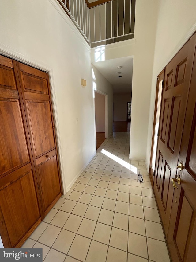 tiled foyer featuring a high ceiling