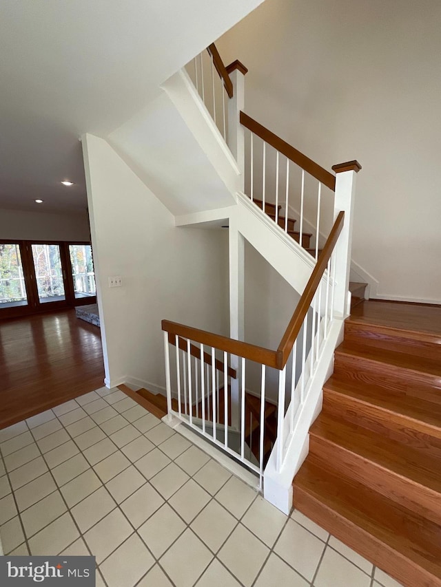 stairs featuring hardwood / wood-style floors