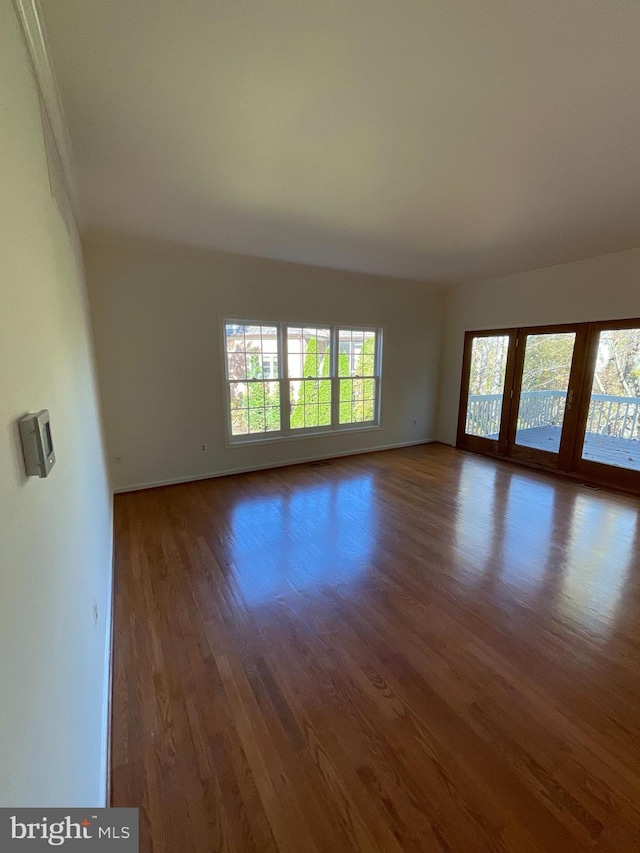 spare room featuring dark hardwood / wood-style flooring