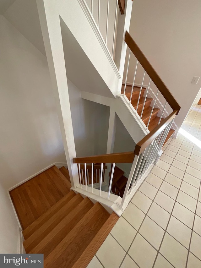 stairs featuring wood-type flooring