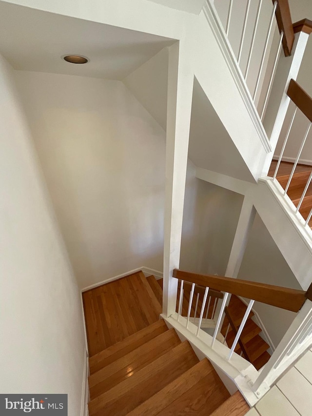 staircase featuring hardwood / wood-style flooring