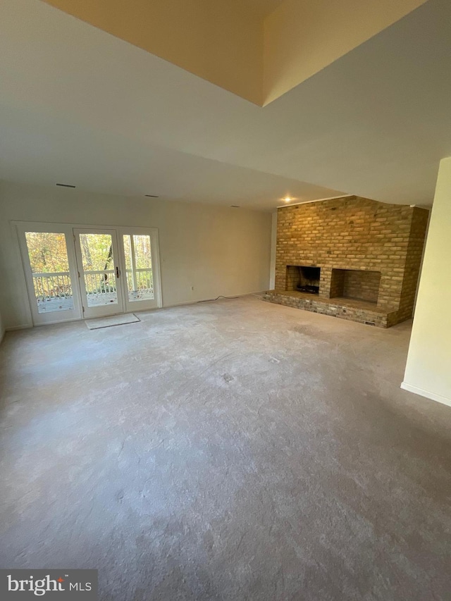 unfurnished living room with a fireplace and carpet flooring