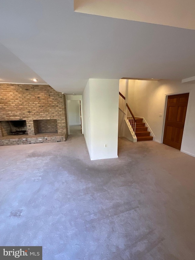 unfurnished living room with a fireplace and carpet flooring