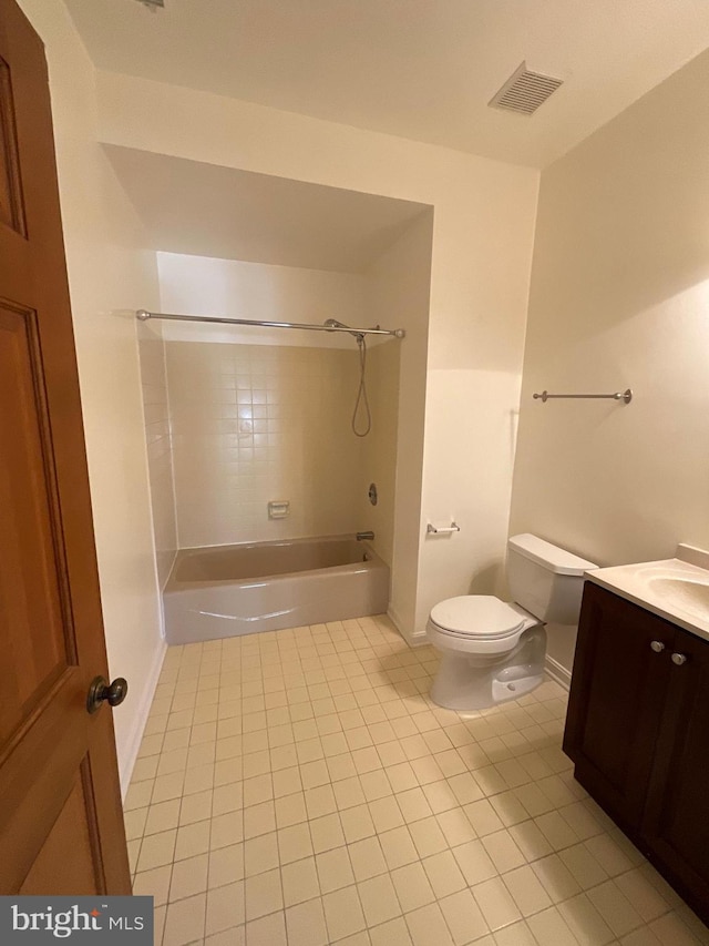 full bathroom with tile patterned flooring, tiled shower / bath combo, toilet, and vanity