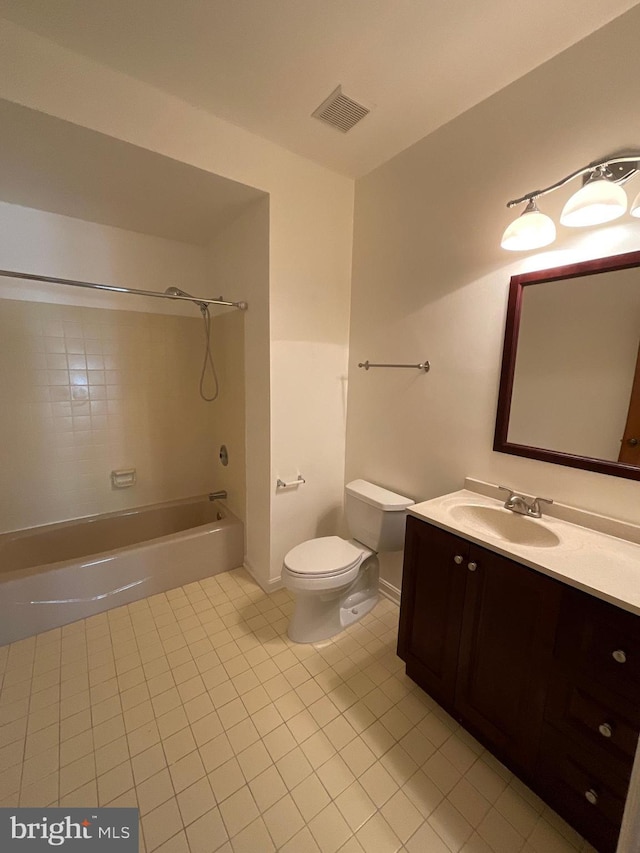 full bathroom with tile patterned floors, tiled shower / bath combo, toilet, and vanity