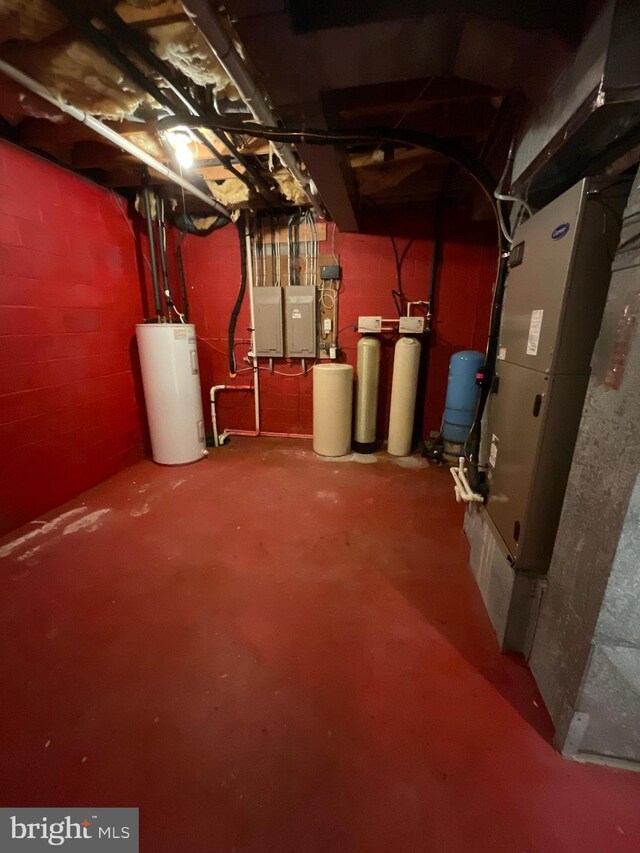 basement with heating unit, electric panel, and water heater