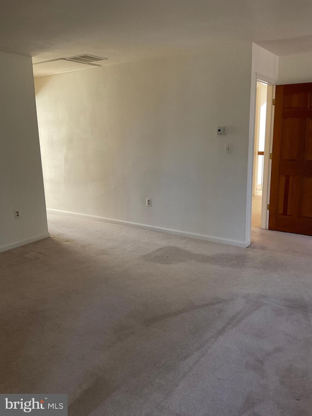 empty room featuring light colored carpet