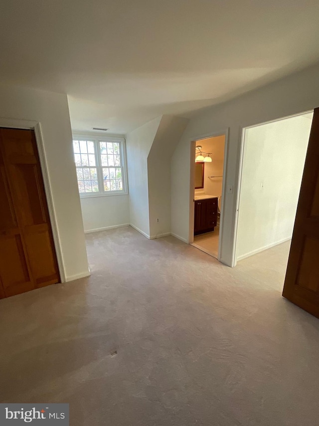 bonus room with light carpet