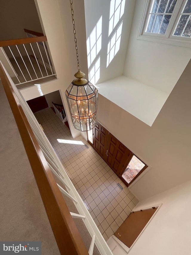 interior space with a notable chandelier and a high ceiling