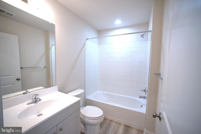 full bathroom featuring hardwood / wood-style floors, vanity, bathing tub / shower combination, and toilet