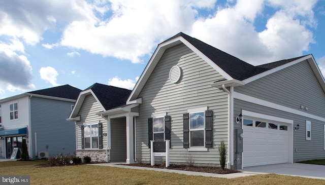 view of front of property featuring a garage and a front lawn