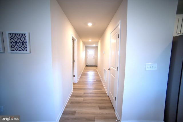 hallway with light wood-type flooring