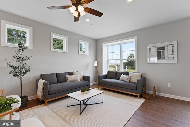 living room with hardwood / wood-style floors, ceiling fan, and a healthy amount of sunlight