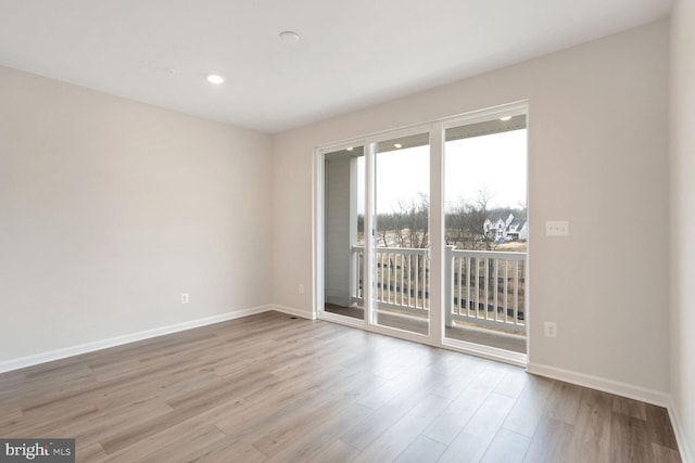 empty room with light hardwood / wood-style flooring