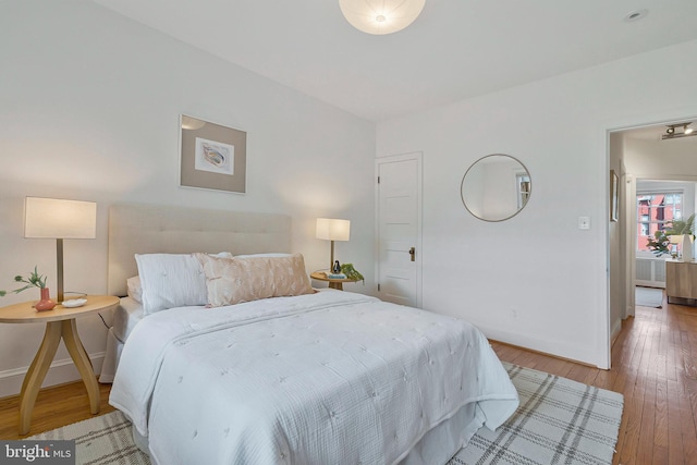 bedroom with wood-type flooring