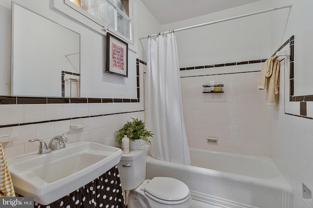 full bathroom featuring tile walls, sink, shower / bath combination with curtain, and toilet