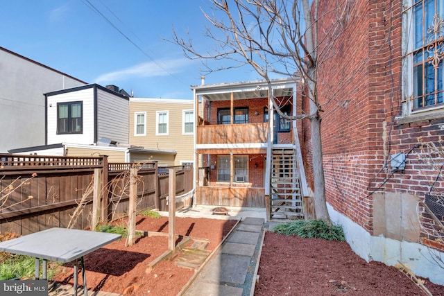 rear view of house featuring a balcony