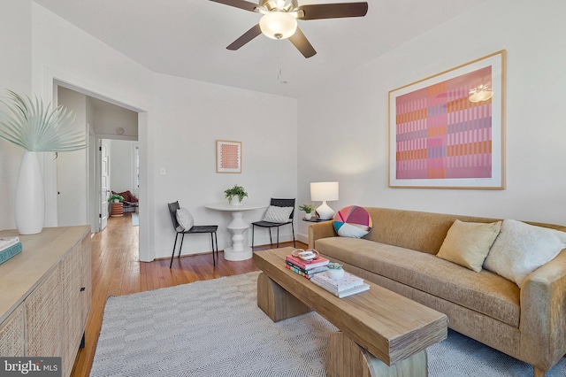 living room with ceiling fan and light hardwood / wood-style flooring