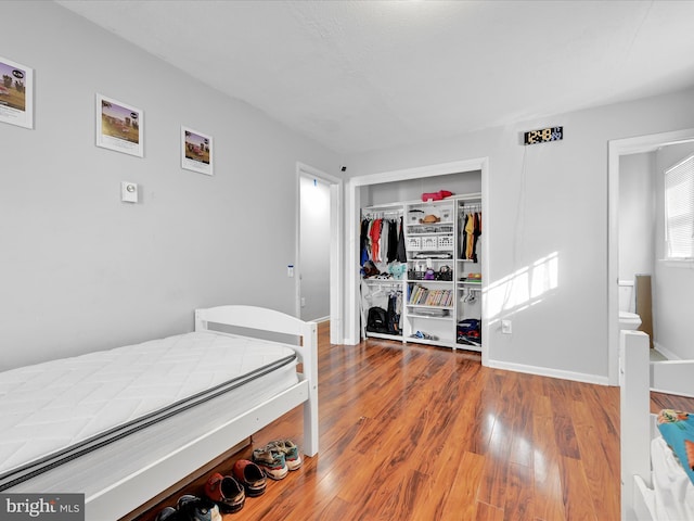 bedroom featuring wood-type flooring and a closet