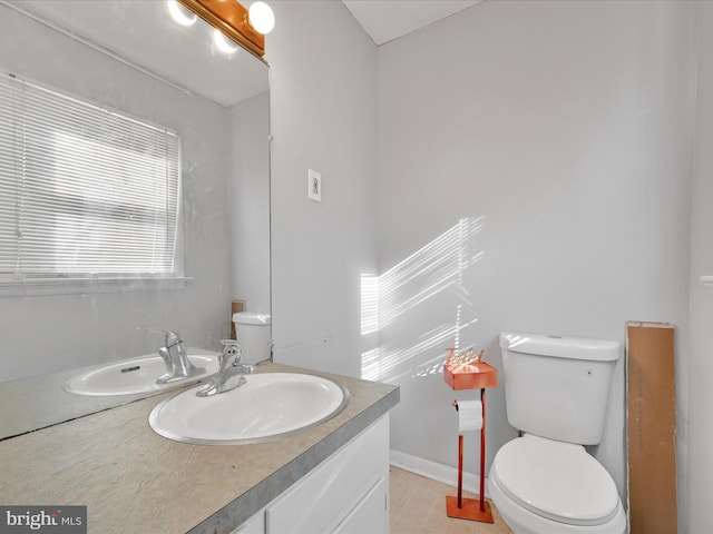 bathroom featuring tile patterned floors, vanity, and toilet