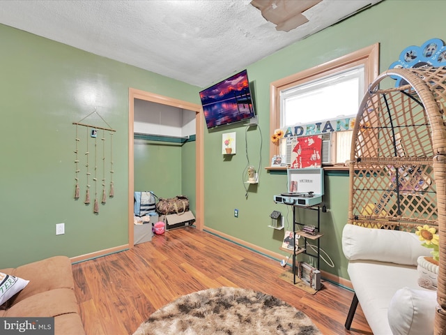 sitting room featuring hardwood / wood-style floors and a textured ceiling