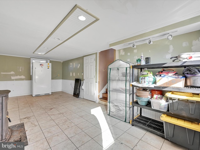 interior space featuring tile patterned floors and white fridge