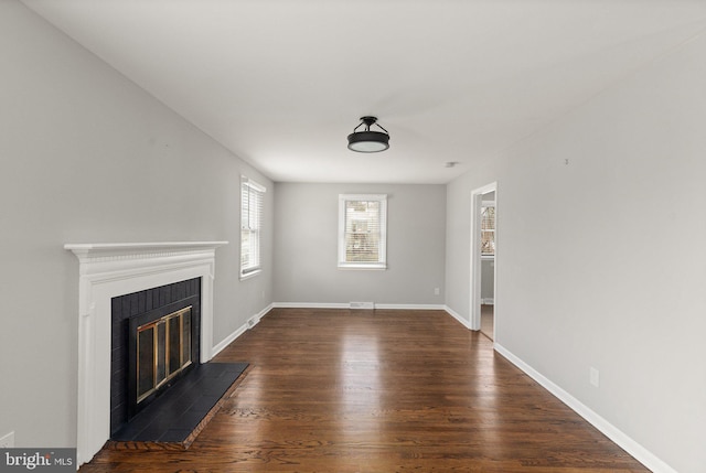 unfurnished living room featuring dark hardwood / wood-style flooring