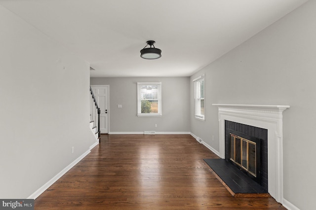 unfurnished living room with dark hardwood / wood-style flooring