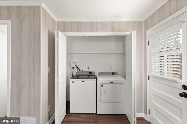 laundry room with washer and clothes dryer, dark hardwood / wood-style floors, and ornamental molding