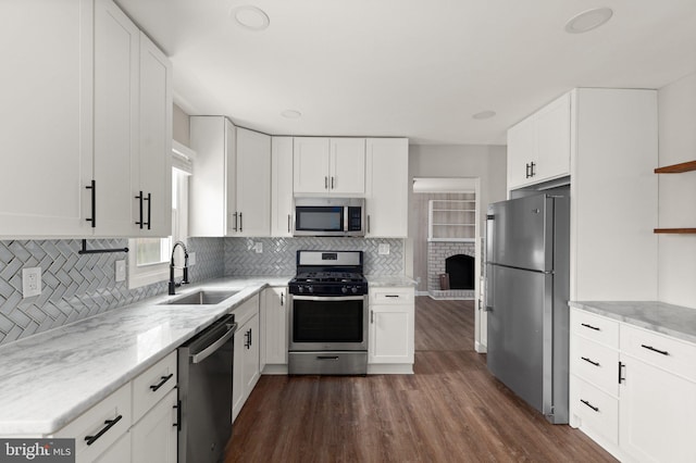 kitchen with sink, white cabinetry, stainless steel appliances, and dark wood-type flooring