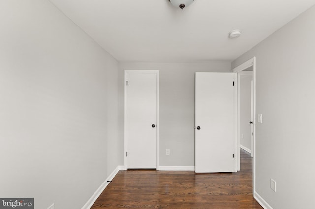 unfurnished bedroom featuring dark hardwood / wood-style flooring