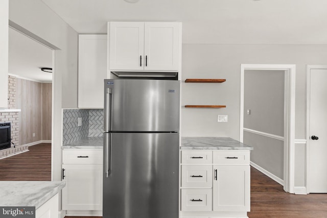 kitchen featuring tasteful backsplash, stainless steel refrigerator, white cabinetry, and dark hardwood / wood-style floors