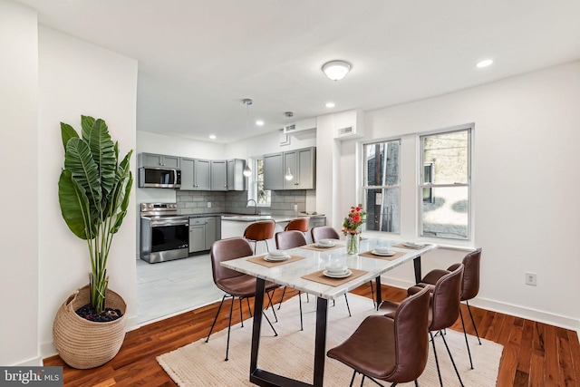 dining area featuring dark wood-type flooring and sink