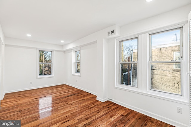 unfurnished room featuring hardwood / wood-style flooring