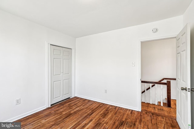 unfurnished room with dark hardwood / wood-style floors