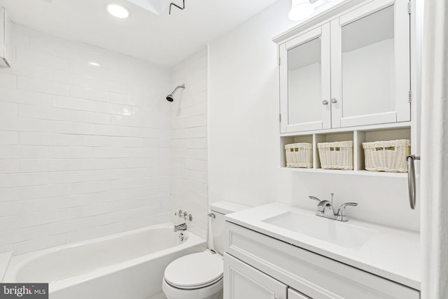 full bathroom featuring vanity, toilet, and tiled shower / bath