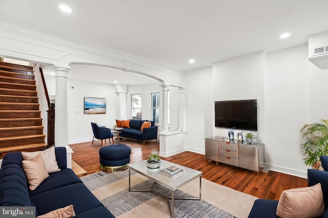 living room featuring decorative columns and hardwood / wood-style floors