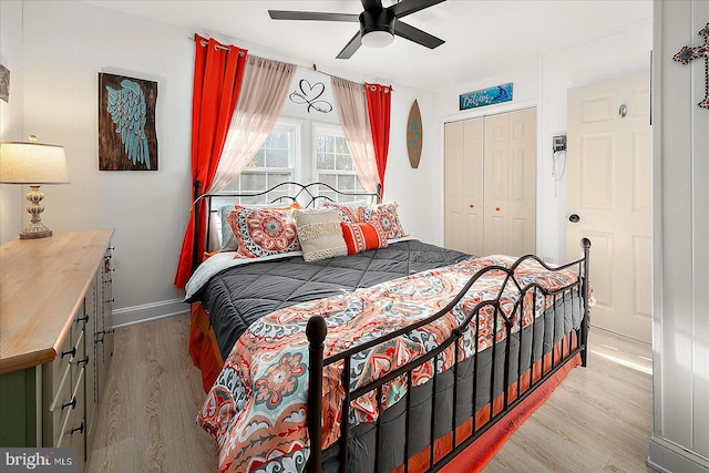 bedroom featuring ceiling fan, light hardwood / wood-style floors, and a closet