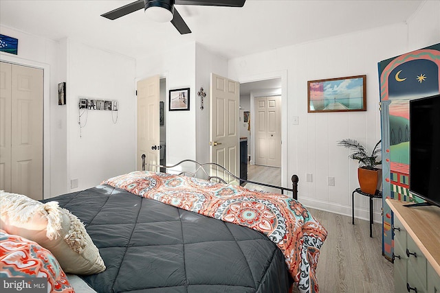 bedroom with ceiling fan, a closet, and light wood-type flooring