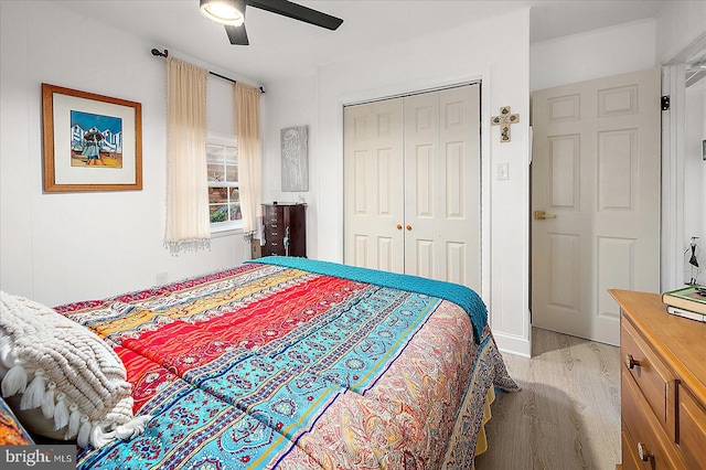 bedroom featuring ceiling fan, light wood-type flooring, and a closet