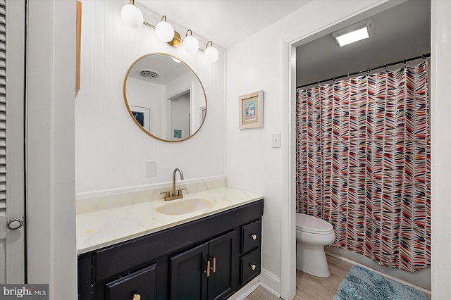 bathroom with a shower with curtain, hardwood / wood-style floors, vanity, and toilet