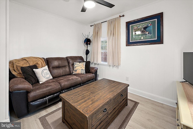 living room with crown molding, ceiling fan, and light wood-type flooring