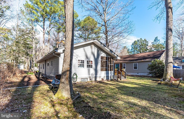 rear view of property featuring a lawn