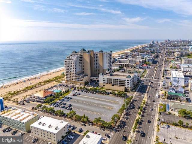 birds eye view of property with a water view and a view of the beach