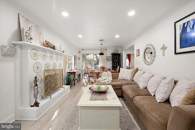 living room featuring light hardwood / wood-style floors and ornamental molding