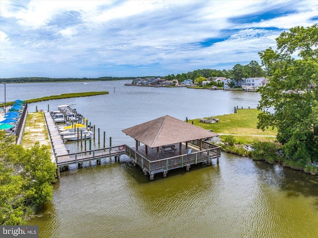 view of dock featuring a water view and a lawn