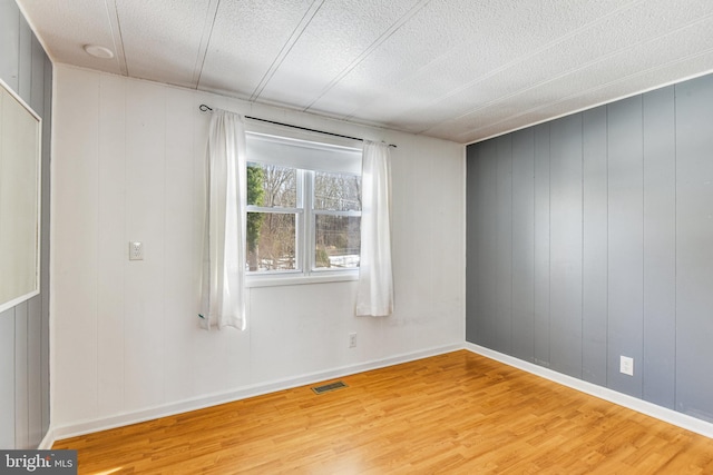 empty room featuring hardwood / wood-style flooring