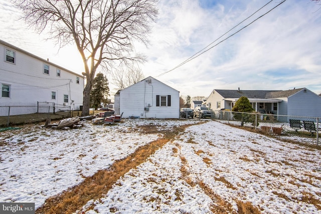 view of snow covered back of property