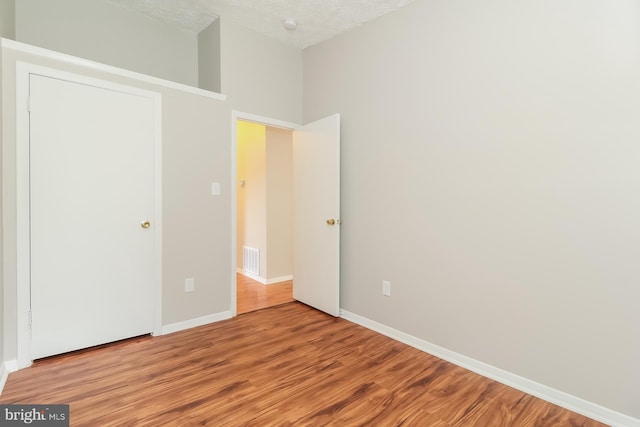 408 Berkshire Ct, Joppa, MD 21085 - unfurnished bedroom featuring wood finished floors and a textured ceiling