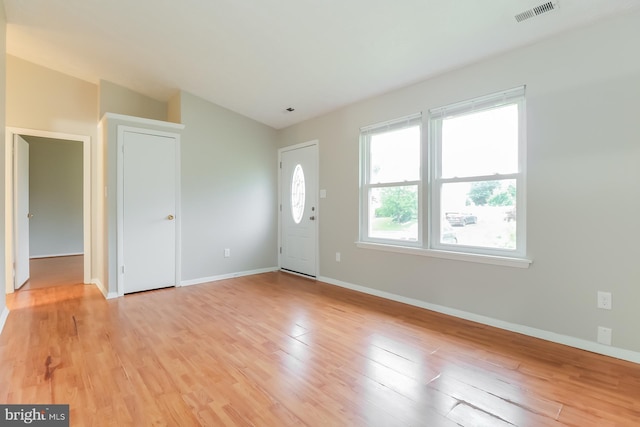 interior space featuring light hardwood / wood-style floors and vaulted ceiling